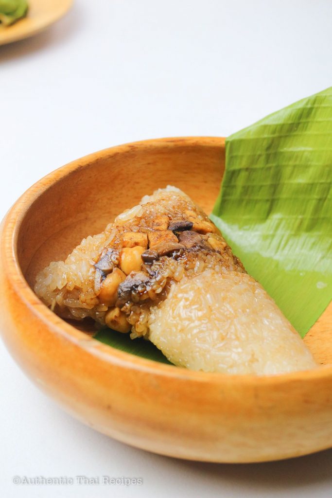 unwrapped Thai sticky rice dumpling on a wooden bowl