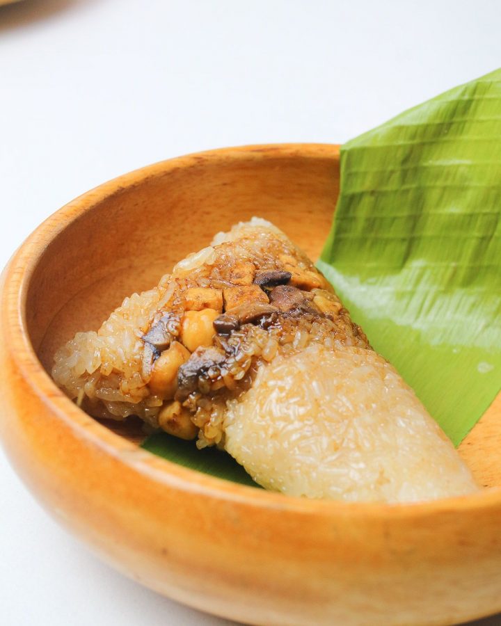 Thai Sticky Rice dumplings in a brown bowl with banana leaves