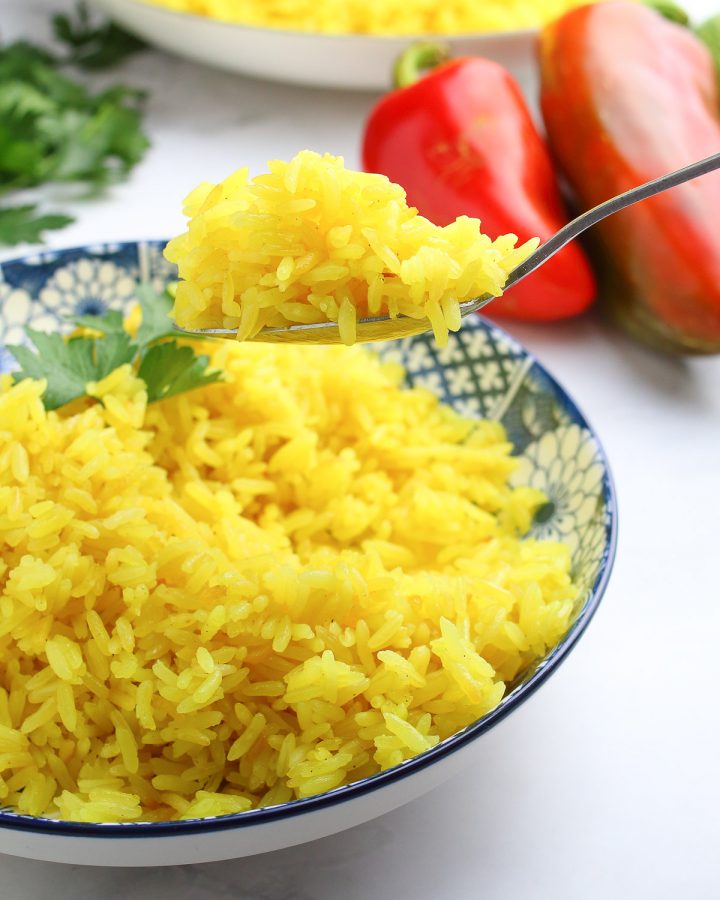 Thai-inspired Coconut Rice in a bowl with a spoonful of rice.