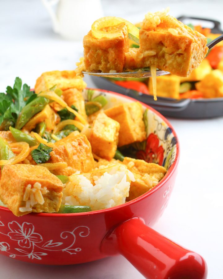 Thai Red curry with rice in a red bowl