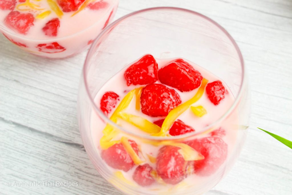 two transparent bowls of thai rubies in coconut milk on a marble table