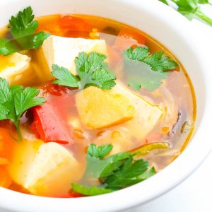 lemongrass thai soup in a white bowl garnished with cilantro