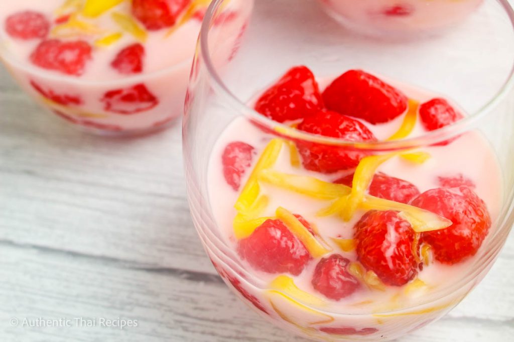 two transparent bowls of rubies in coconut milk thai dessert on a marble table